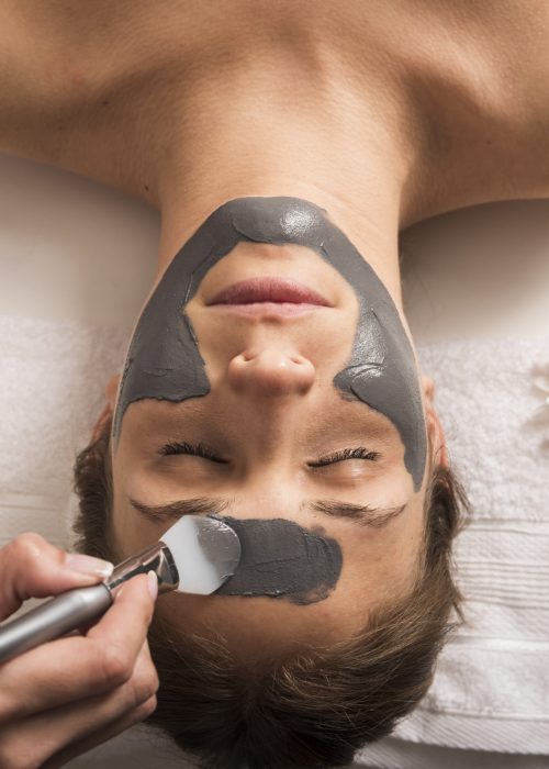 high-angle-view-woman-receiving-facial-mask-beauty-salon